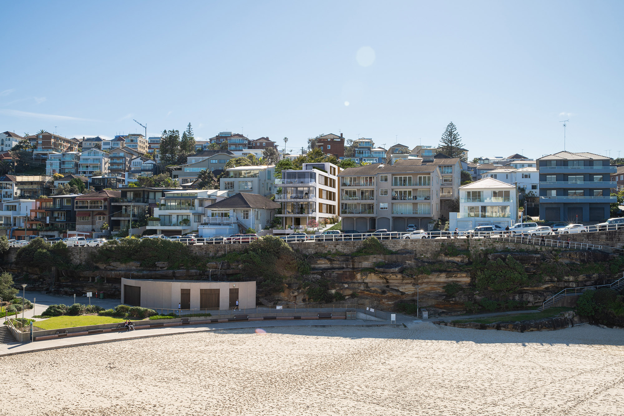 Coastal houses overlooking sandy beach.